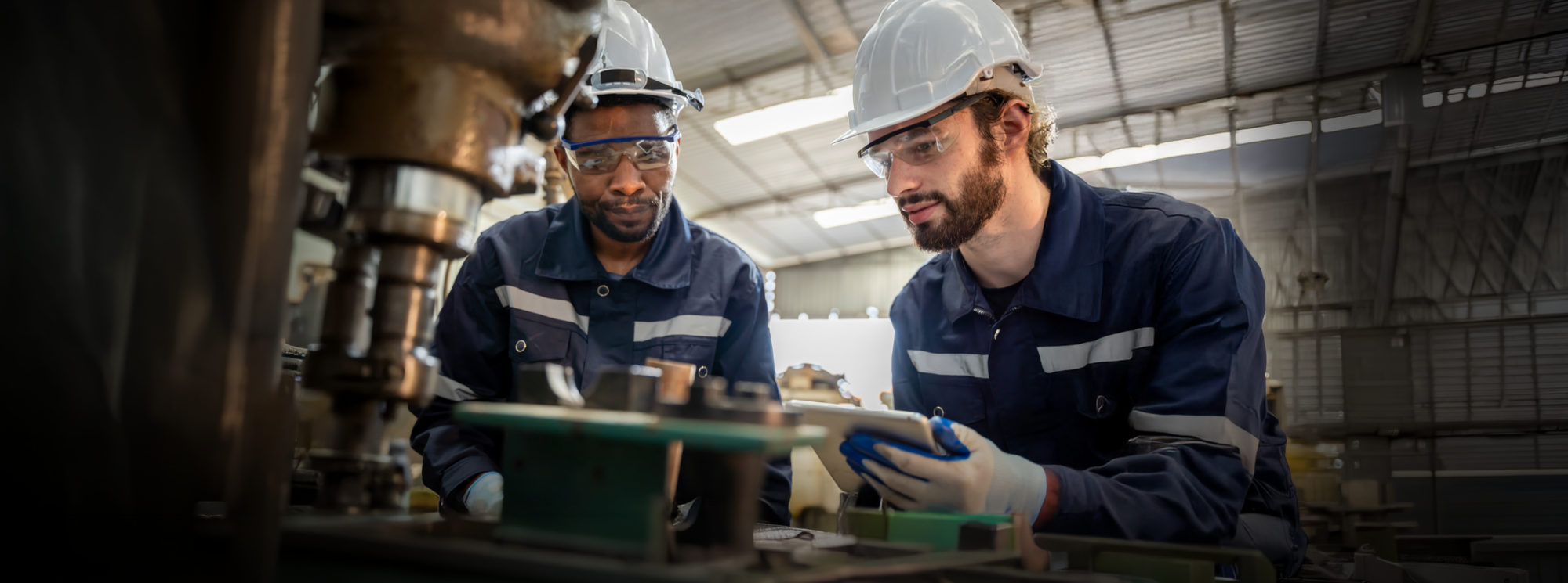 Two Graham Engineering field technicians reviewing a machine component
